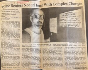 An image of a yellowed, faded news clipping from the LA Times. The article features a black and white image of a man in a tank top with shades at his door. There is a handwritten sign on the door reading -Notice- WARNING: LESTER FINKELSTEIN HAS DIED ANYONE ENTERING THIS APT WITHOUT MY EXPRESS WRITTEN PERMISSION IS BREAKING THE LAW & WILL BE SUED FOR TRESPASS & ILLEGAL ENTRY. 